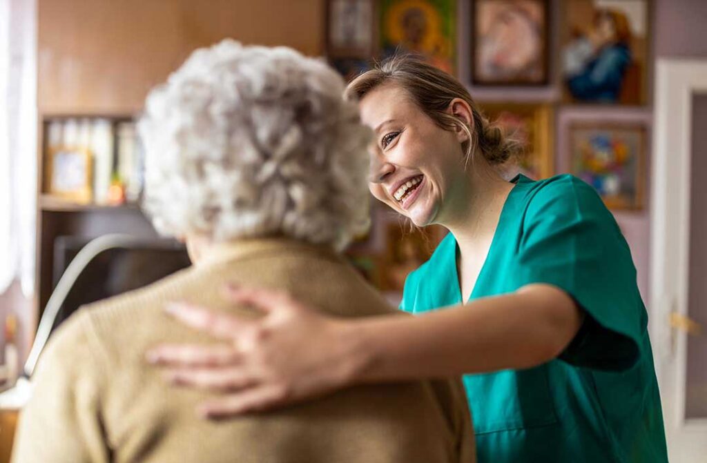 An older adult packing personal items with a relative in a cozy, lived-in living room.