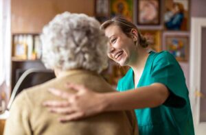 An older adult packing personal items with a relative in a cozy, lived-in living room.